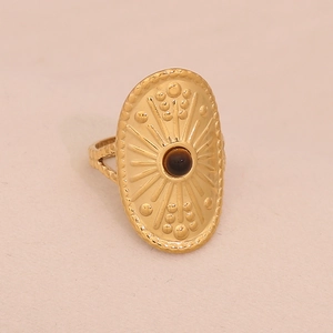 Detailed side view of a gold boho ring featuring sunburst patterns and a brown bead