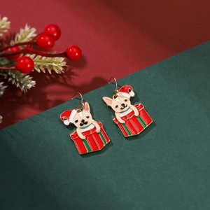 Close-up of festive Christmas bulldog earrings in a striped gift box design