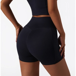 Detail of high-waist black yoga shorts showing peach lift design and premium matte fabric