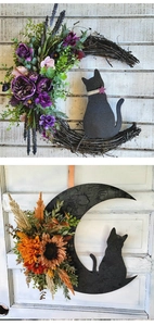 Macro view of moon-shaped twig wreath with glittery black cat and autumn floral accents