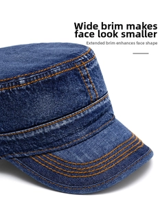Close-up of deep blue washed denim military cap with contrast orange stitching detail