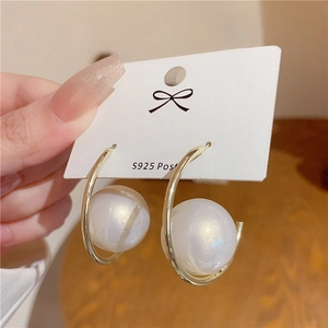 Detail of large white faux pearls on gold circle earrings with S925 silver posts