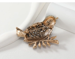 Detailed back view of vintage magpie brooch showing pin clasp and hollow metal structure