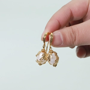 Detail of natural freshwater pearl earrings with gold leaf textures and S925 silver needles