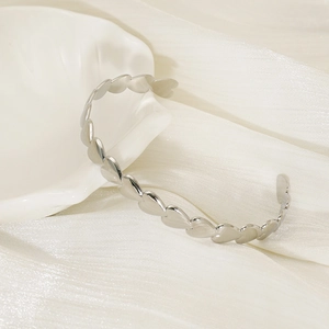 Adjustable silver cuff bracelet with interlocking 3D heart shapes and polished finish