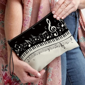 Portable music-themed canvas cosmetic pouch featuring piano keys and musical notes print