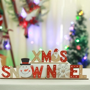 Christmas wooden letter ornaments featuring XMAS SNOW NOEL designs for festive table decor