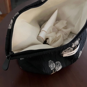 Top view of open floral jacquard makeup bag showing spacious canvas interior storage