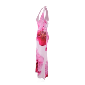Detail of floral halter maxi dress featuring vibrant orchid patterns and backless design