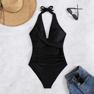 Detailed flat lay of black halter neck swimsuit with pleated abdomen and bow detail