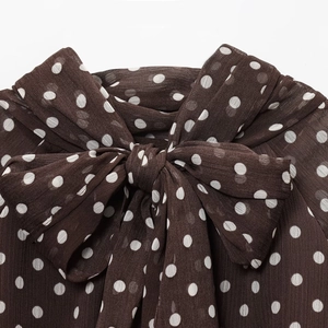 Polka dot chiffon blouse in dark brown with a large bow-tie collar design