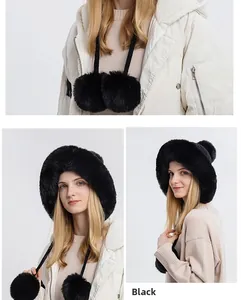 Detail of black faux fur trapper hat with soft knit texture and large fluffy pom-poms