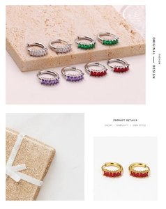 Detail of elegant hoop earrings with multi-colored zircon stones and gold finish