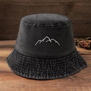 Close-up of a dark grey washed cotton bucket hat with white mountain peak embroidery