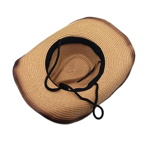 Brown woven western cowboy straw hat with wide brim and adjustable windproof rope
