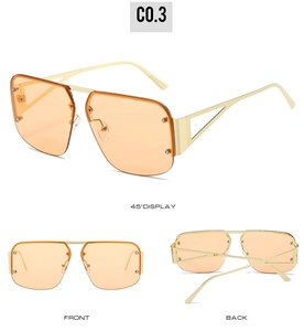 Detail view of orange lens aviator sunglasses with gold metal frame and decorative studs