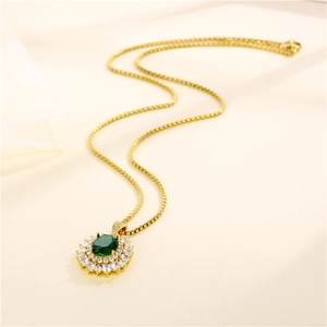 Elegant gold oval pendant necklace with green gemstone and sparkling zircon stones