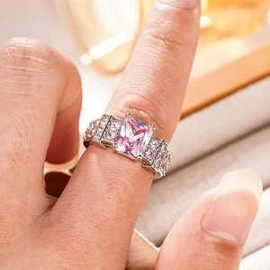 Detailed close-up of a square pink gemstone ring with intricate four-prong setting