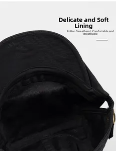 Detail view of the black newsboy cap featuring a breathable cotton sweatband and lining
