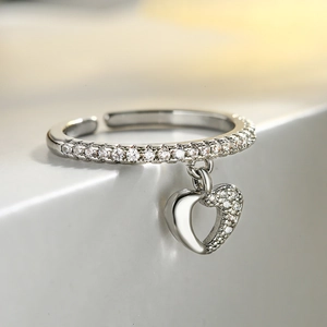 Minimalist silver open ring with dangling heart pendant and shimmering zircon accents