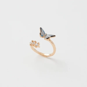 Détail de la bague ouverte en or rose avec papillon en émail bleu et cristaux brillants
