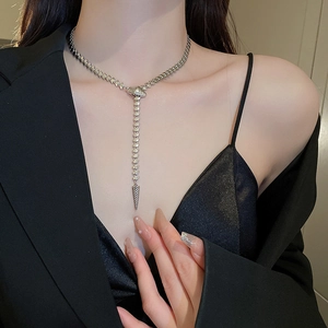 Silver Y-shaped snake chain necklace worn by a model in a luxury close-up shot