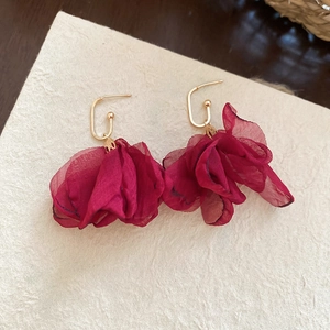 Detail of dark red chiffon flower earrings with elegant gold metal geometric hooks