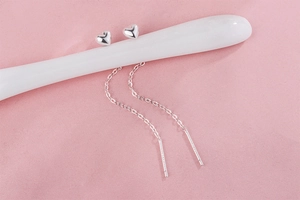 Detailed view of S925 sterling silver long tassel ear wires with polished heart studs