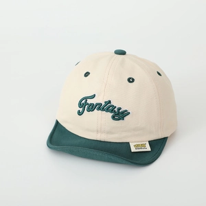 Detail of soft cotton baby cap with Fantasy 3D embroidery and green contrast brim
