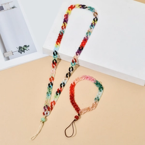 Detail view of colorful acrylic resin phone strap set with rainbow links on flat lay surface