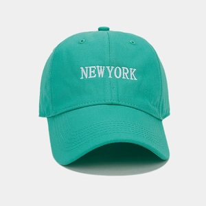 Close-up of NEW YORK white embroidery on high-quality green cotton baseball cap