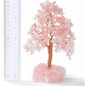 Detail of rose quartz money tree on stone base measuring 18cm with scale ruler