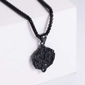 Retro black stainless steel box chain with embossed dragon pendant on a white pedestal