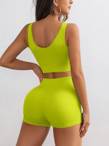 Detail of lime green ribbed seamless yoga set showing high waist and knit texture