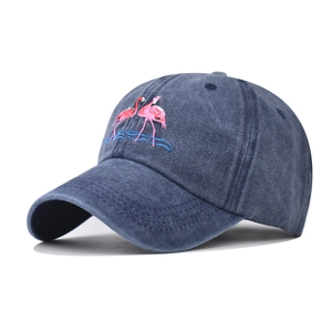 Washed dark blue denim baseball cap with pink flamingo embroidery and retro casual design