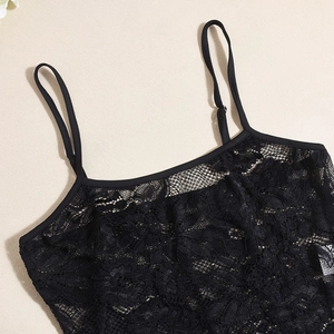 Detail of black lace camisole showing delicate floral patterns and adjustable straps