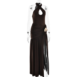 Detail of dark brown halter dress with chest cutout, gold bow, and high side slit