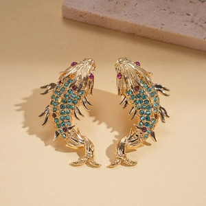New Chinese-style gold koi fish earrings with colorful crystals on a stone background