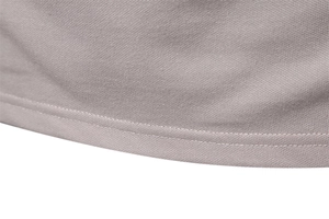 Close-up of khaki polo shirt hem featuring breathable honeycomb mesh fabric and stitching
