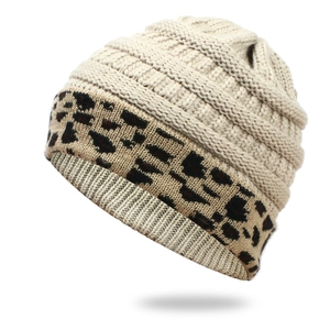 Close-up of beige knit beanie with leopard print cuff and warm fleece lining