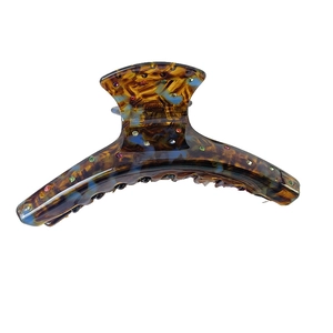 Elegant tortoiseshell resin hair claw clip with colorful rhinestones on a white background