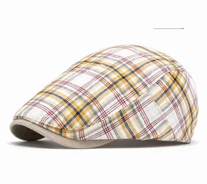 Detail view of the yellow plaid flat cap with a contrast brown brim and breathable fabric