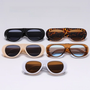 Detailed view of various retro oversized sunglasses in black, white, and tortoiseshell