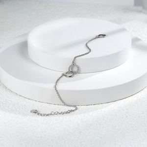 Elegant silver-plated double interlocking circle bracelet with shimmering diamond accents