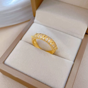 Detailed macro shot of gold-plated ring featuring micro-pave cubic zirconia on velvet