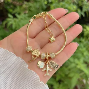 Travel-themed 18K gold-plated snake chain charm bracelet with sparkling airplane pendants