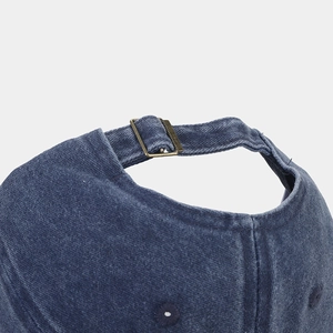 Detail of navy blue corduroy baseball cap with vintage bronze metal adjustable buckle
