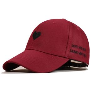Detail of burgundy baseball cap featuring black heart and LOVE HER BUT LEAVE HER WILD embroidery