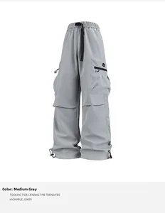 Detalle de pantalones cargo con cinturón de hebilla funcional y bajos con cordón