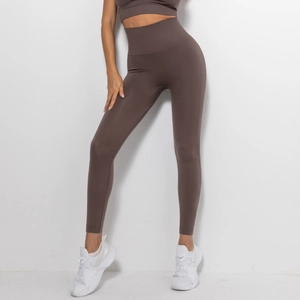 Detail of high-waist seamless compression yoga set in chocolate brown with supportive waistband